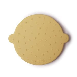 Silikonowy żółty gryzak w kształcie twarzy dla niemowlaka. Mushie Sylikonowy Gryzak Face Banana Cream