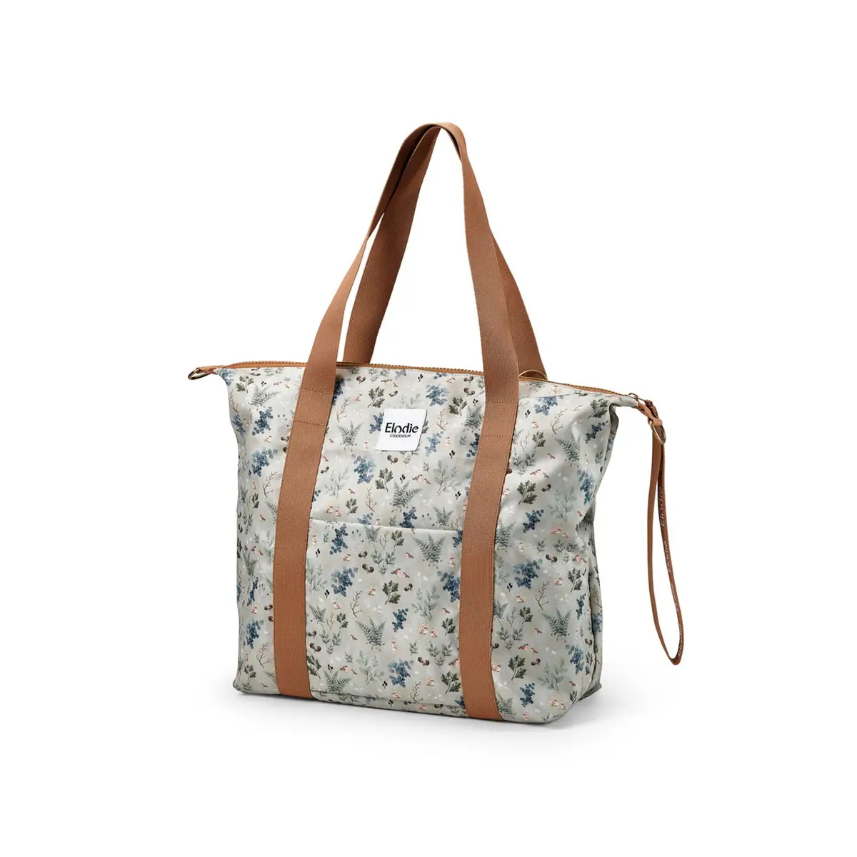 Torba dla mamy w jasnym kolorze w drobne kwiaty z brązowymi uchwytami i paskiem do noszenia na ramieniu. Elodie Details Torba dla mamy Soft Shell Fairytale Forest