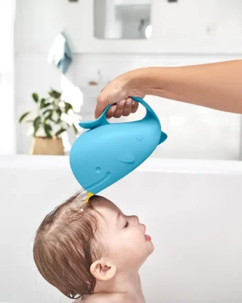Niebieski kubek do mycia głowy w kształcie wieloryba używany do polewania głowy dziecka podczas kąpieli. Skip Hop Kubek do Mycia Głowy Wieloryb Moby Blue 710 ml