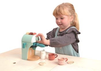 Drewniany ekspres do kawy na kapsułki w kolorze miętowym z akcesoriami dla dziecka dziewczynka bawi się zabawką. Tender Leaf Toys Drewniany ekspres do kawy na kapsułki