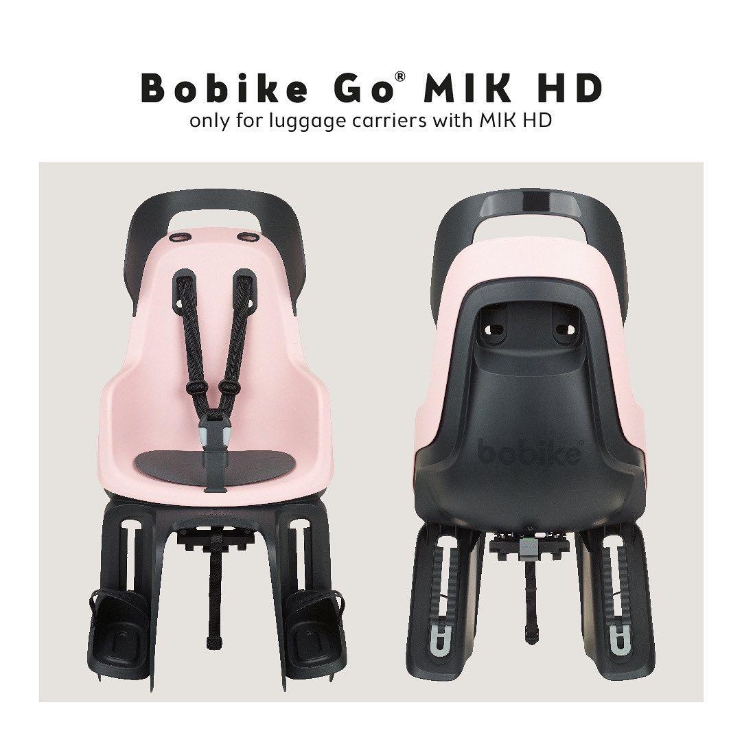 Fotelik rowerowy dla dziecka na bagażnik w kolorze różowym z czarnymi elementami z pasami bezpieczeństwa. Bobike Fotelik row. GO bagażnik MIK HD Candy Pink