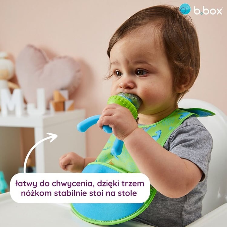 Silikonowy gryzak do podawania pokarmu w kolorze zielonym z niebieskimi nóżkami dla niemowlaka. b.box Gryzak silikonowy do podawania pokarmu Strawberry Shake