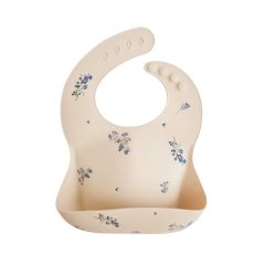Silikonowy śliniak w kolorze jasnobeżowym z fioletowymi kwiatami dla dziecka. Mushie Śliniak Silikonowy Lilac Flowers