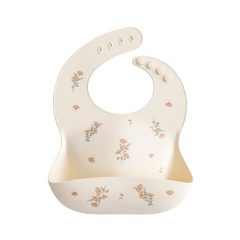 Silikonowy śliniak w kremowym kolorze w różowe kwiaty dla dziecka. Mushie Śliniak Silikonowy Pink Flowers