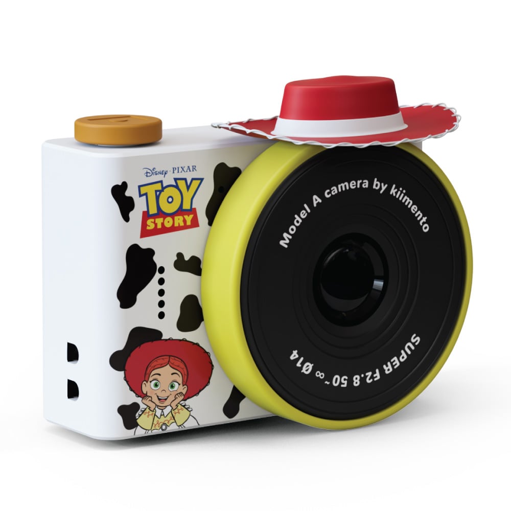 Aparat fotograficzny dla dzieci biały z czarnymi łatami i żółtym obiektywem z motywem kowbojki Jessie z Toy Story. Kiimento Aparat Mini dla Dzieci Kowbojka Jessie z Toy Story