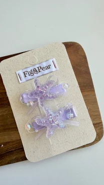 Liliowe spinki do włosów w kształcie rozgwiazd z brokatem, 2 sztuki. Fig&Pear Liliowe spinki rozgwiazdy 2 pak