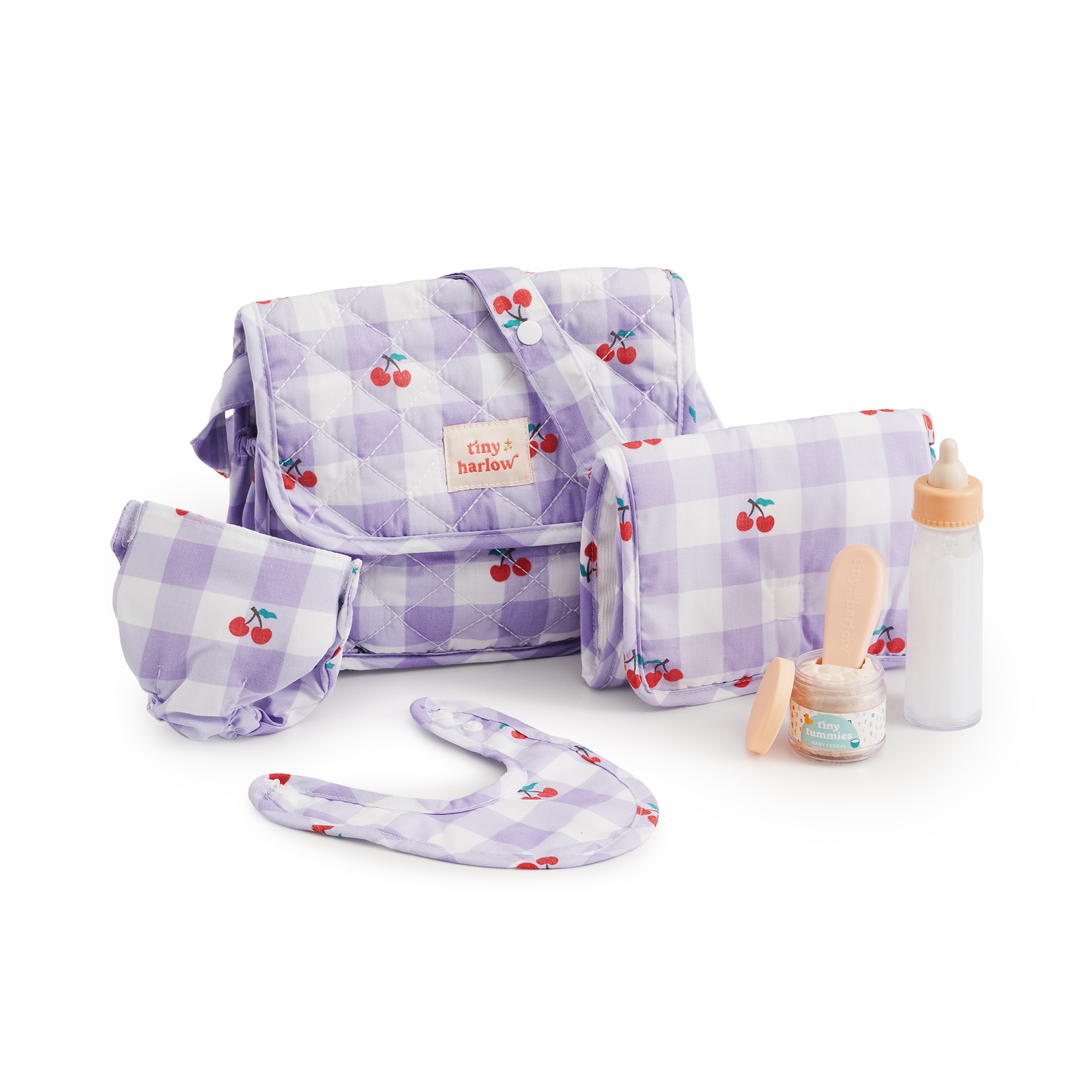 Torba dla lalek w liliową kratkę z motywem wiśni, z małą saszetką, opaską i akcesoriami dla dziecka. Tiny Harlow Torba z akcesoriami dla lalek Lilac Cherry